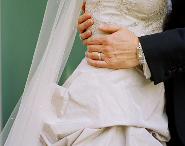 Close-up of bride and groom embrace - wedding photo by top Austin based wedding photographers Q Weddings